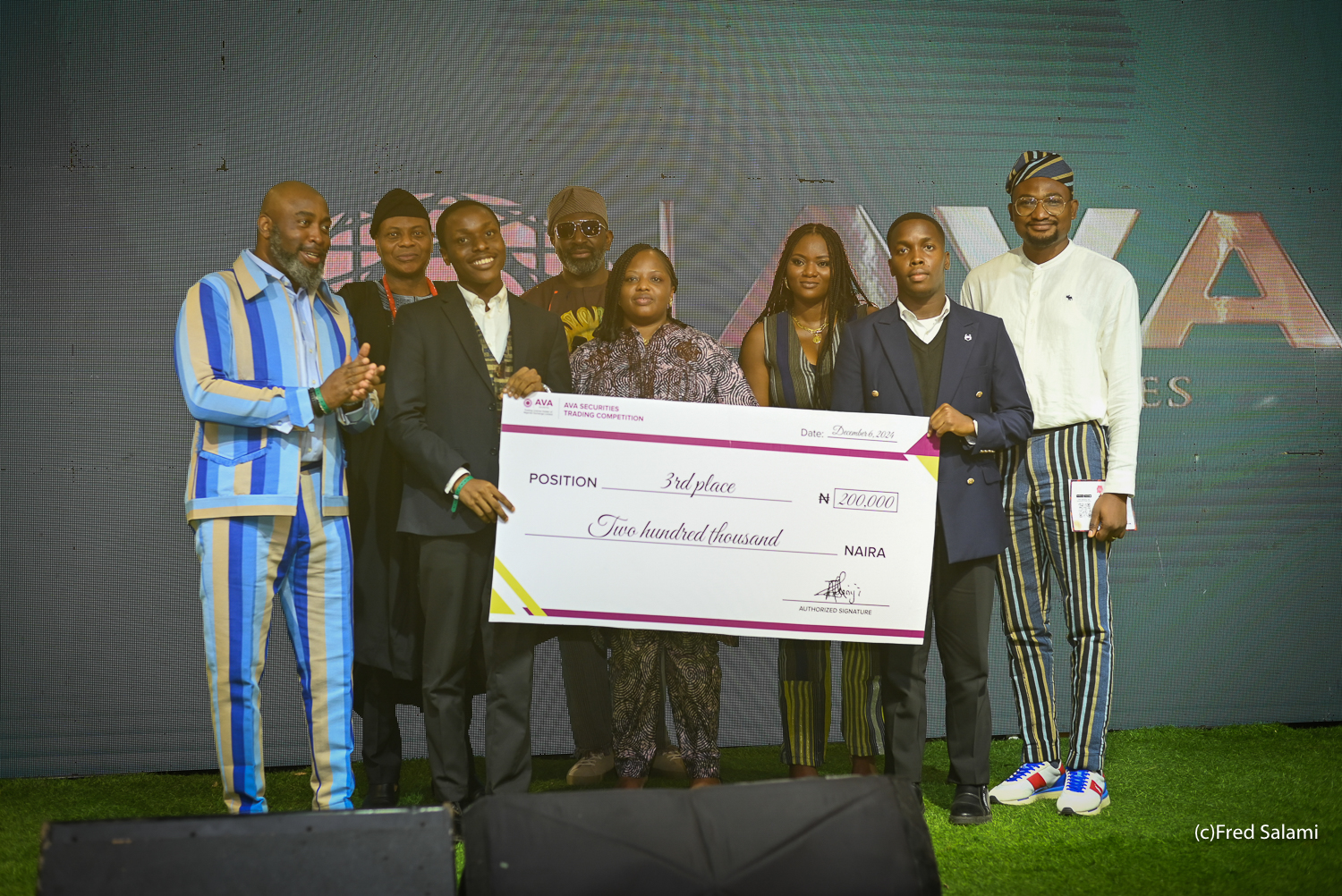 3rd place team receiving a ₦200,000 cheque on stage